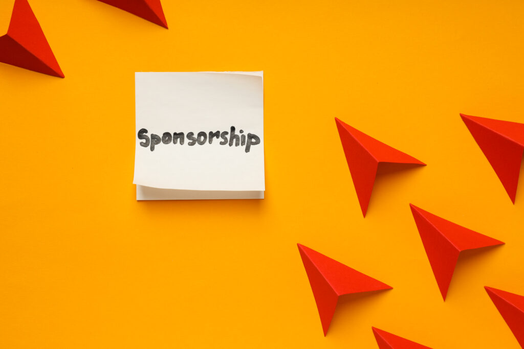 Paper planes flying towards a note with the word sponsorship, symbolising UK sponsor licence routes for workers and temporary workers.