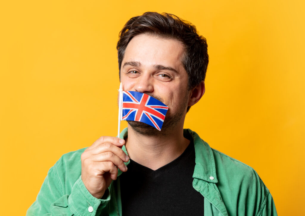 Person holding the UK flag, symbolising compliance with the UK Sponsor Management System (SMS).