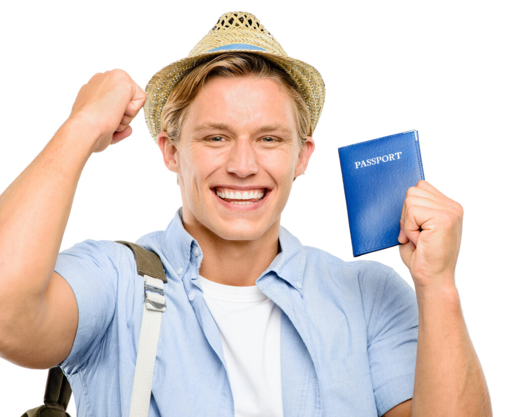 Smiling man holding a blue passport and celebrating, symbolising successful visa or sponsor licence approval.