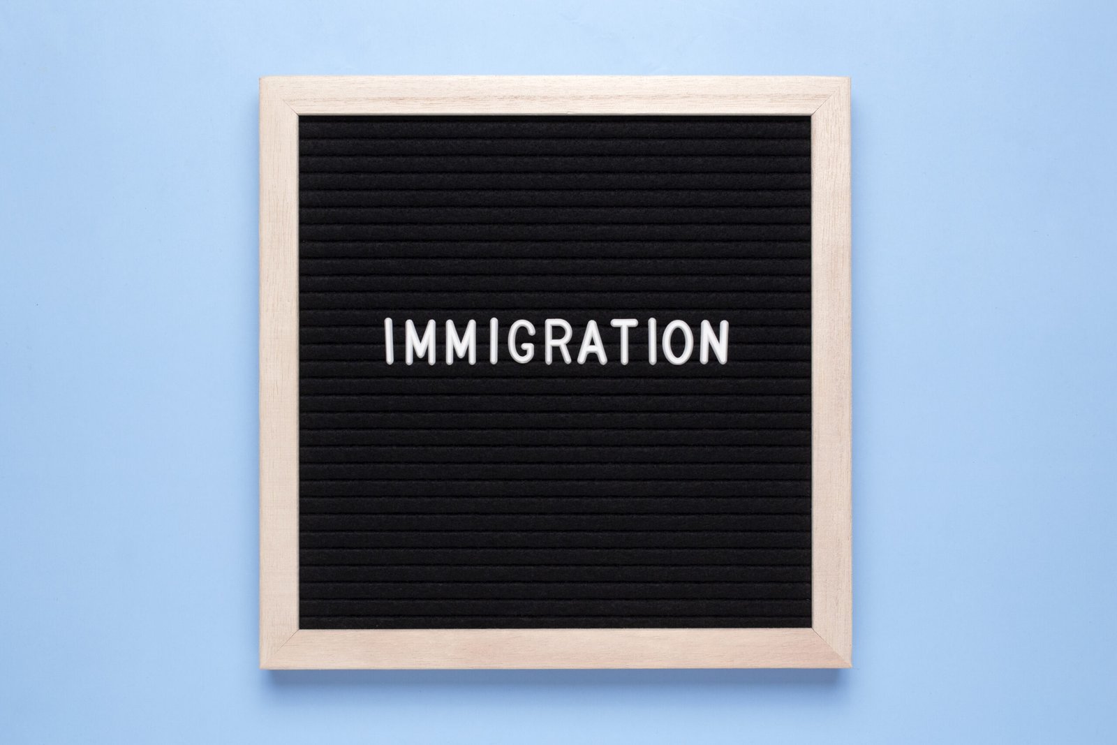 A professional office setting with HR and management staff reviewing immigration compliance documents, representing the impact of the 2025 Immigration White Paper on employer responsibilities in the UK.