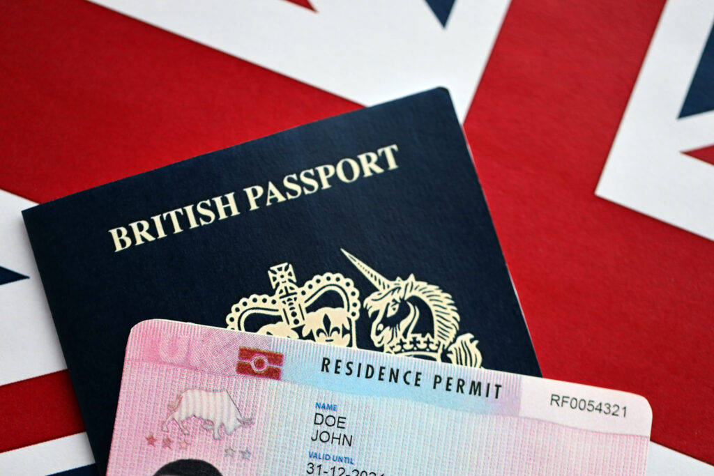 Illustration showing UK employers navigating the 2025 Immigration White Paper changes, including skill thresholds, workforce training, and recruitment strategy adjustments.