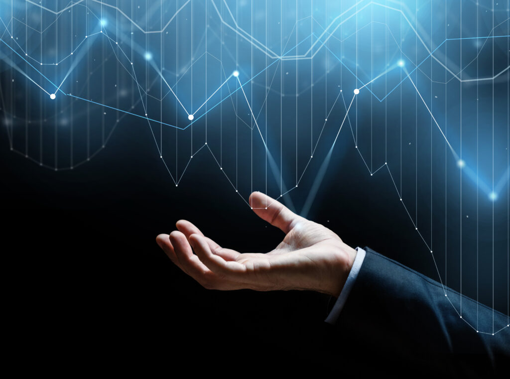 An HR professional reviewing Certificates of Sponsorship planning charts and annual hiring calendars on a laptop, illustrating the forecasting of defined and undefined CoS for organisational staffing needs.