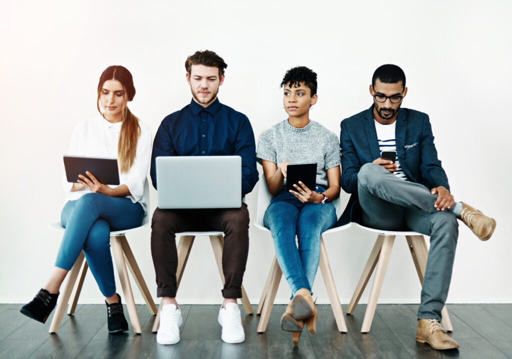 A UK tech employer reviewing sponsor licence documents while recruiting skilled international tech workers in 2025.