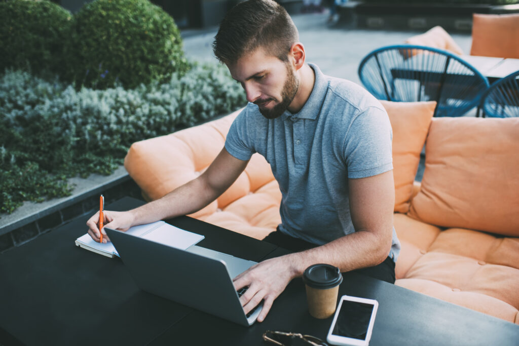 A business professional reviewing contractor agreements on a laptop, symbolising compliance with UK sponsor licence rules for freelancers and remote workers.