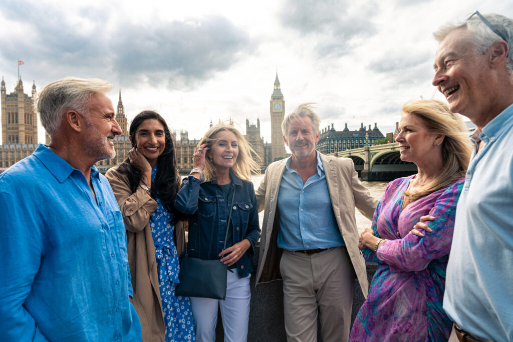 An employer checking a digital share code on a tablet while cross‑referencing a “Certificate of Sponsorship” document on a laptop screen.