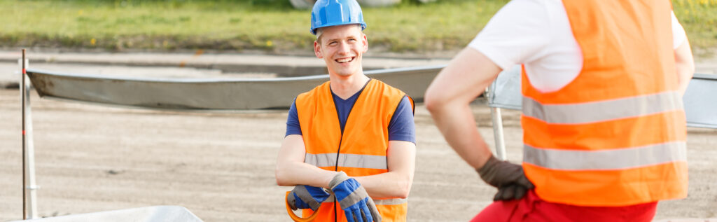 A professional business meeting between a UK employer, a consultant, and a sponsored worker discussing compliance for client-site deployments under current 2025 Skilled Worker sponsor licence rules.