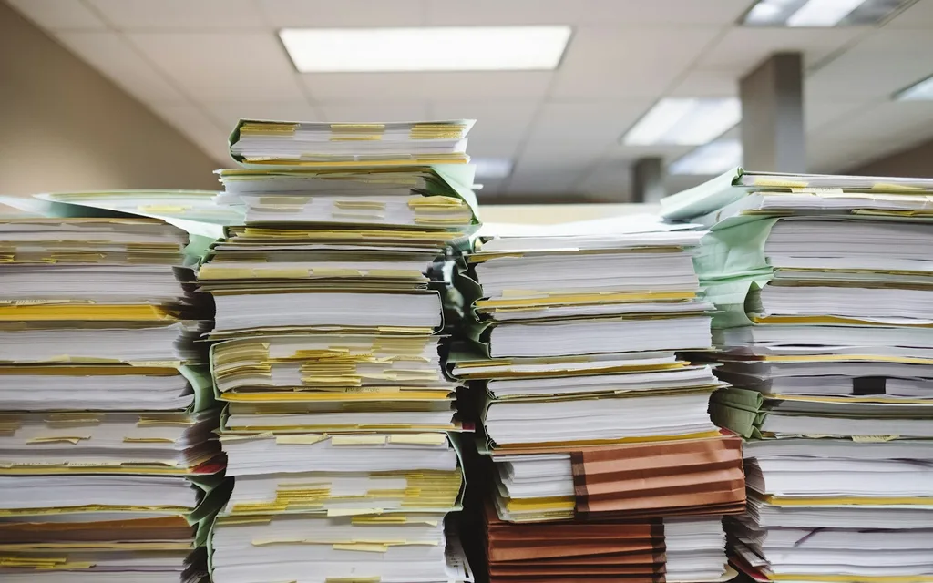 stacks of paper documents and file folders